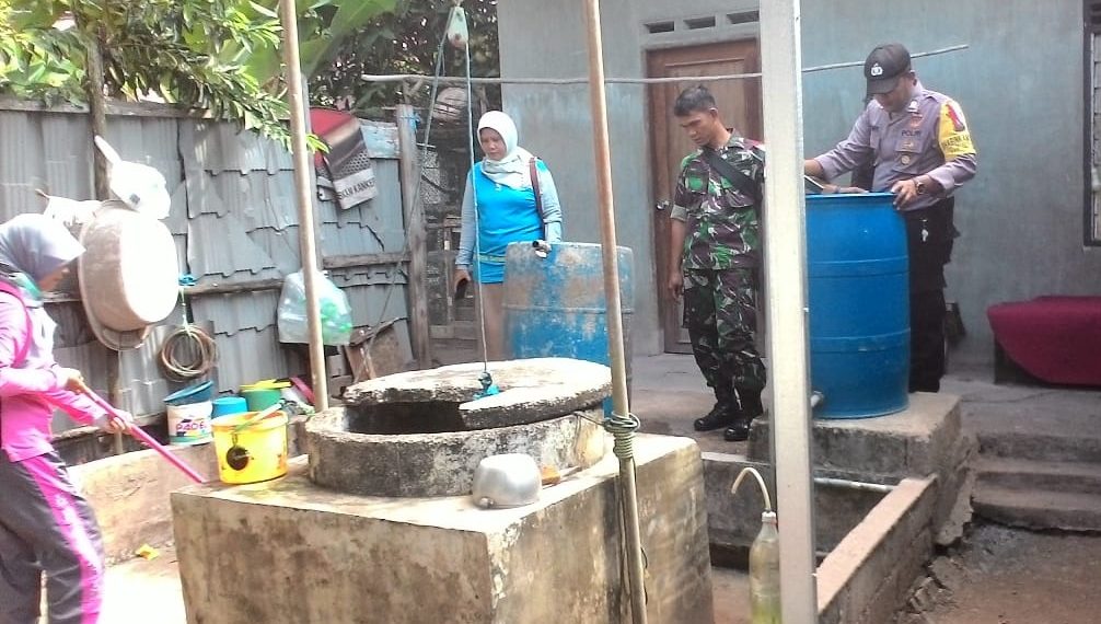 Dua Personil Bhabinkamtibmas Polres Tanjungpinang Bersihkan Lingkungan Warga